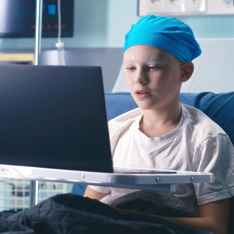 Child cancer patient on a laptop